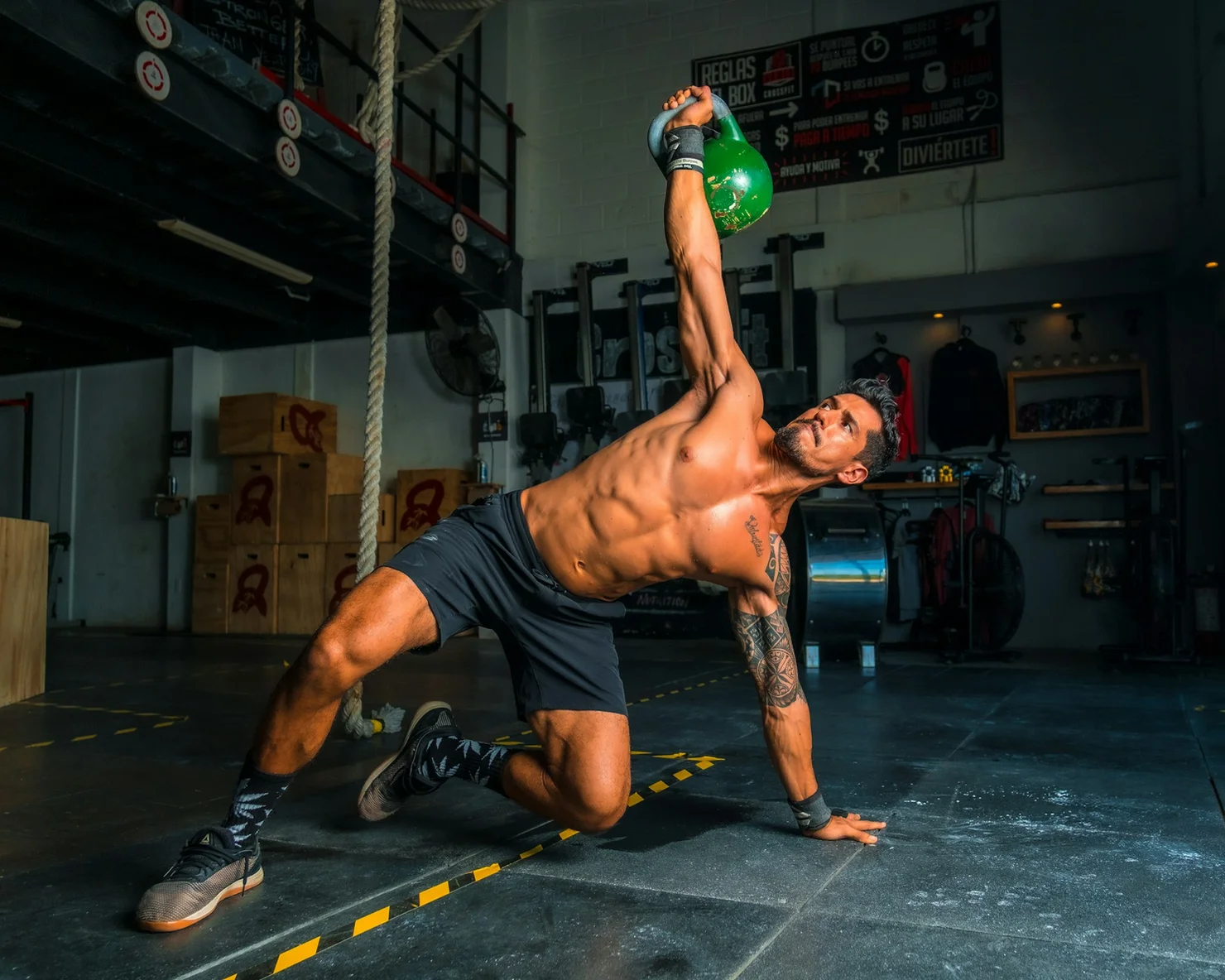 Athlete doing Turkish get-ups with a kettlebell